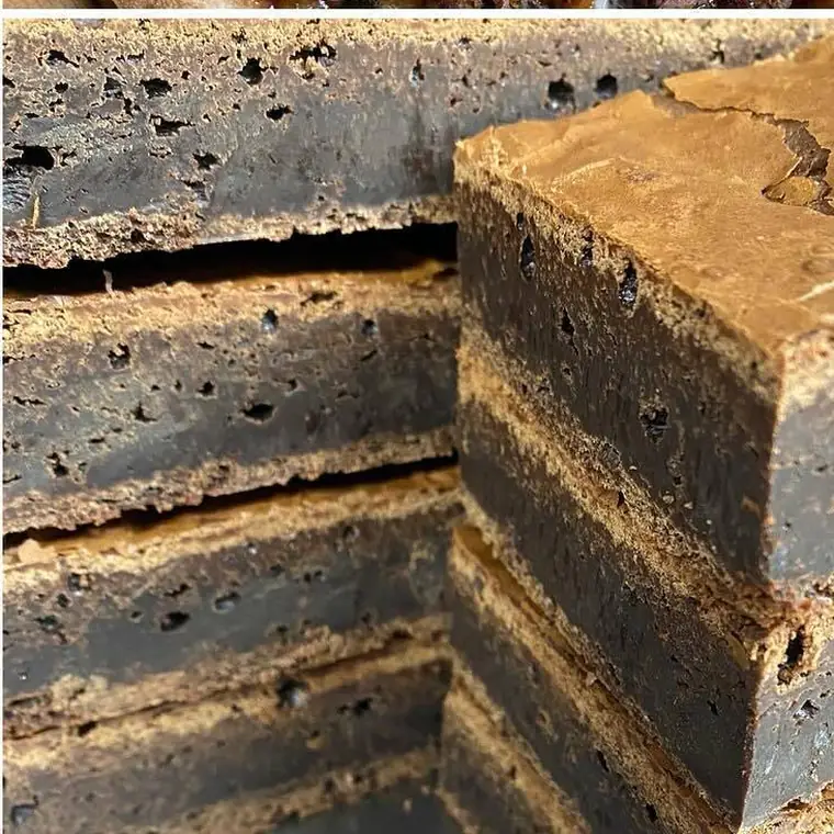 A close-up of the kitchen's gooey chocolate brownies, cut to show the fudgy layers inside.